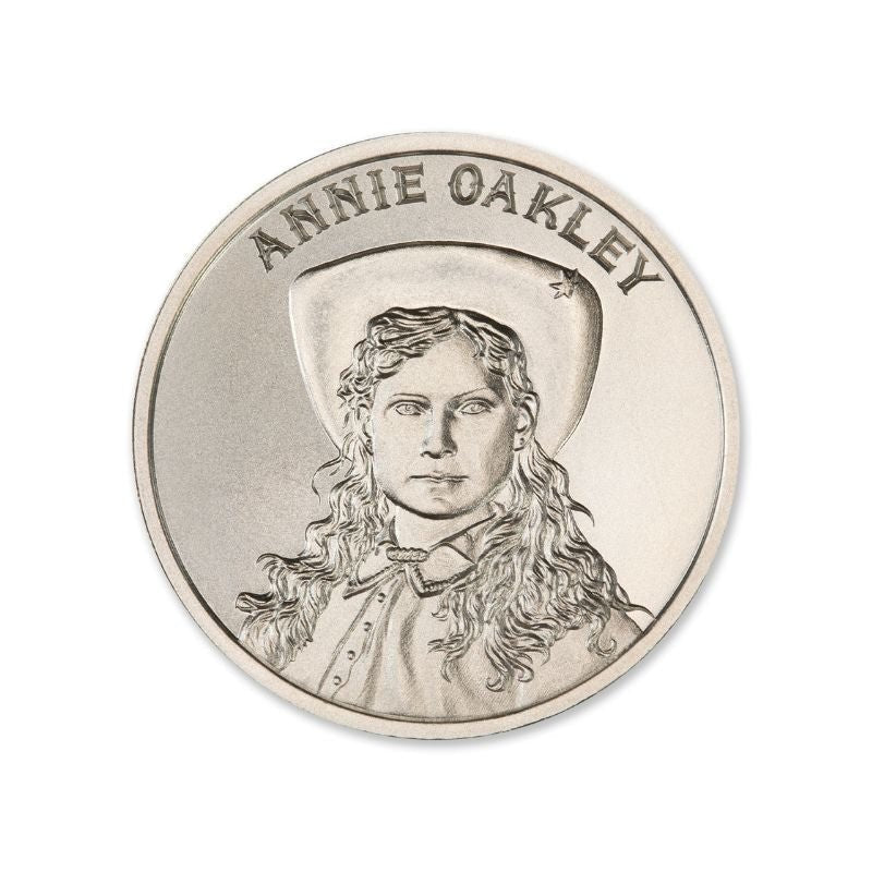 Annie Oakley 2 Troy Ounce 39mm Silver Round featuring a detailed depiction of Annie Oakley and iconic old west imagery.