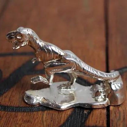 Hand-poured silver bar featuring a detailed T-Rex design, highlighting the prehistoric might and majestic presence of the legendary Tyrannosaurus Rex.