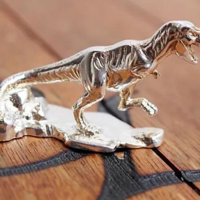 Hand-poured silver bar featuring a detailed T-Rex design, highlighting the prehistoric might and majestic presence of the legendary Tyrannosaurus Rex.