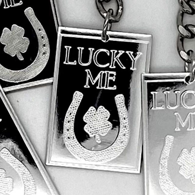 Hand-poured silver keychain featuring intricate designs inspired by timeless lucky charms, embodying symbols of good fortune and positivity.