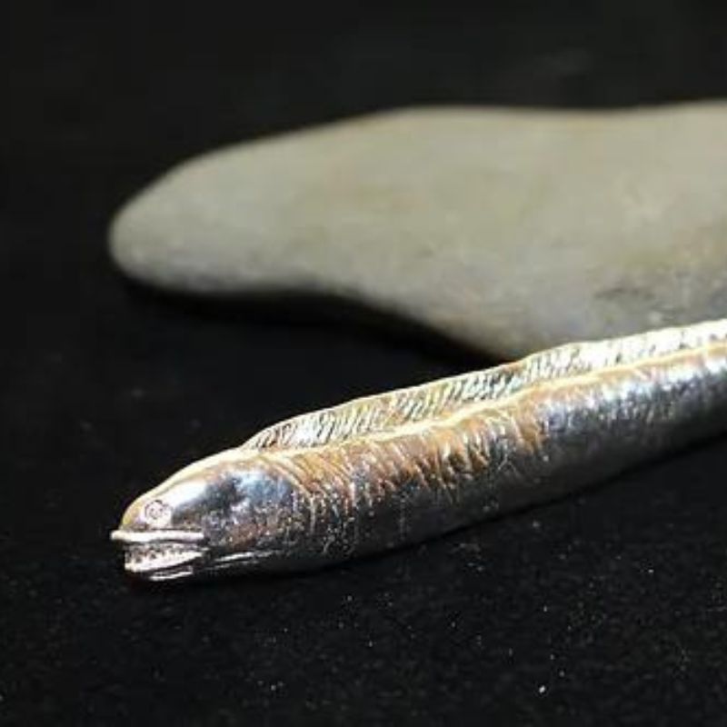 Moray Eel Hand-Poured Silver - Artisan-crafted silver piece showcasing the unique appearance and behavior of moray eels.