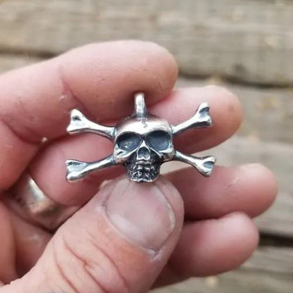 Skull n Bones Silver Round featuring a bold skull and crossed bones design, crafted from .999 fine silver with darkened details. Ideal for collectors and rebels alike.