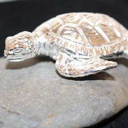 Small Sea Turtle Silver Round crafted from .999 fine silver, featuring an intricate design of a sea turtle. A tranquil and collectible tribute to ocean life.