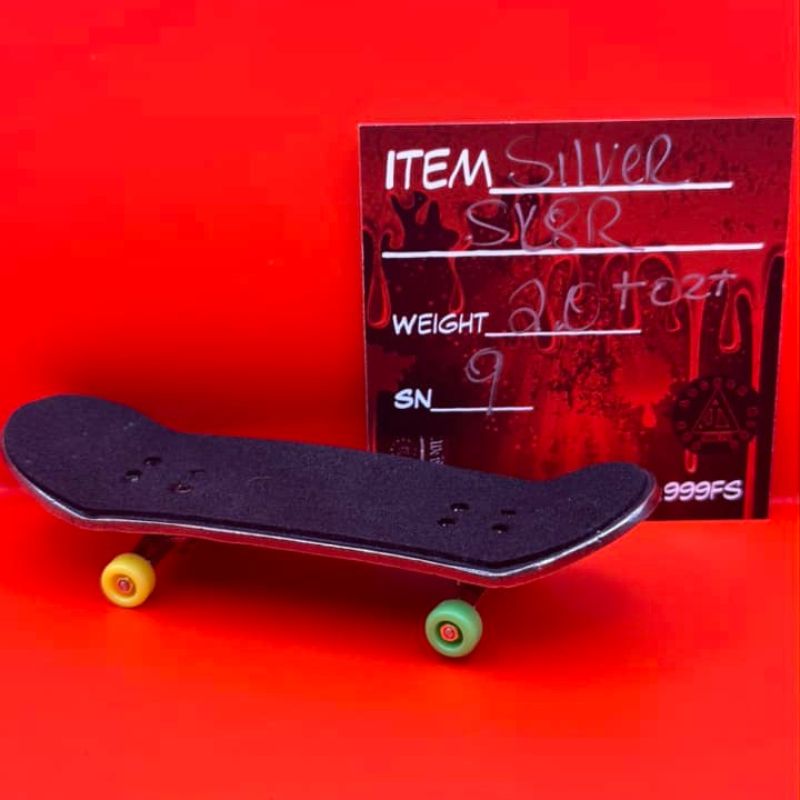 THE LOCKER MINT 2 oz Skateboard in .999 Fine Silver with TechDeck G-Metal Finish – a detailed skateboard design with a dark, metallic appearance.