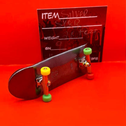 THE LOCKER MINT 2 oz Skateboard in .999 Fine Silver with TechDeck G-Metal Finish – a detailed skateboard design with a dark, metallic appearance.