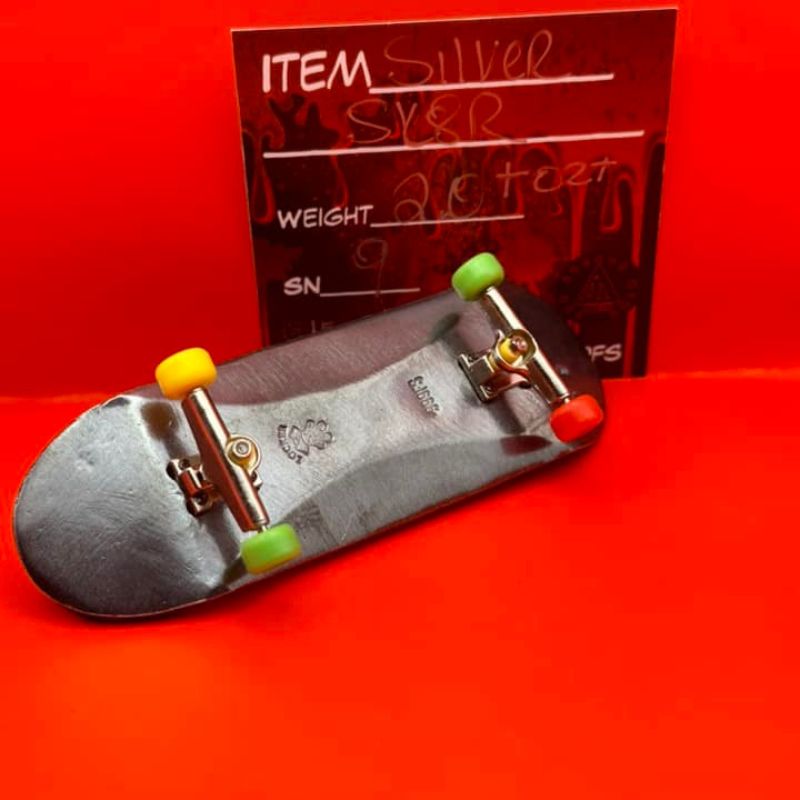 THE LOCKER MINT 2 oz Skateboard in .999 Fine Silver with TechDeck G-Metal Finish – a detailed skateboard design with a dark, metallic appearance.