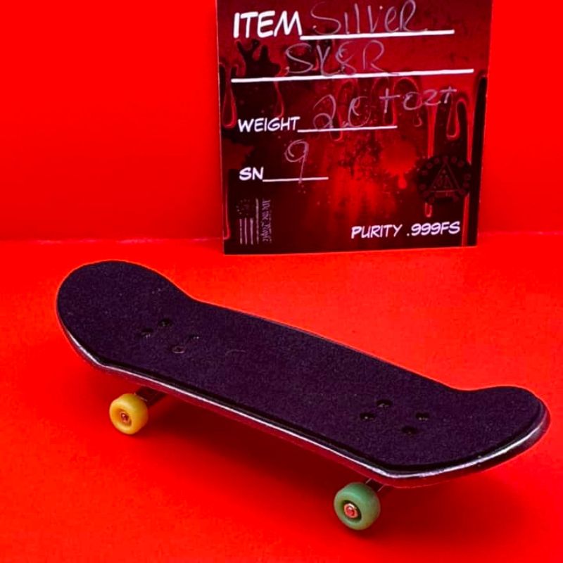 THE LOCKER MINT 2 oz Skateboard in .999 Fine Silver with TechDeck G-Metal Finish – a detailed skateboard design with a dark, metallic appearance.